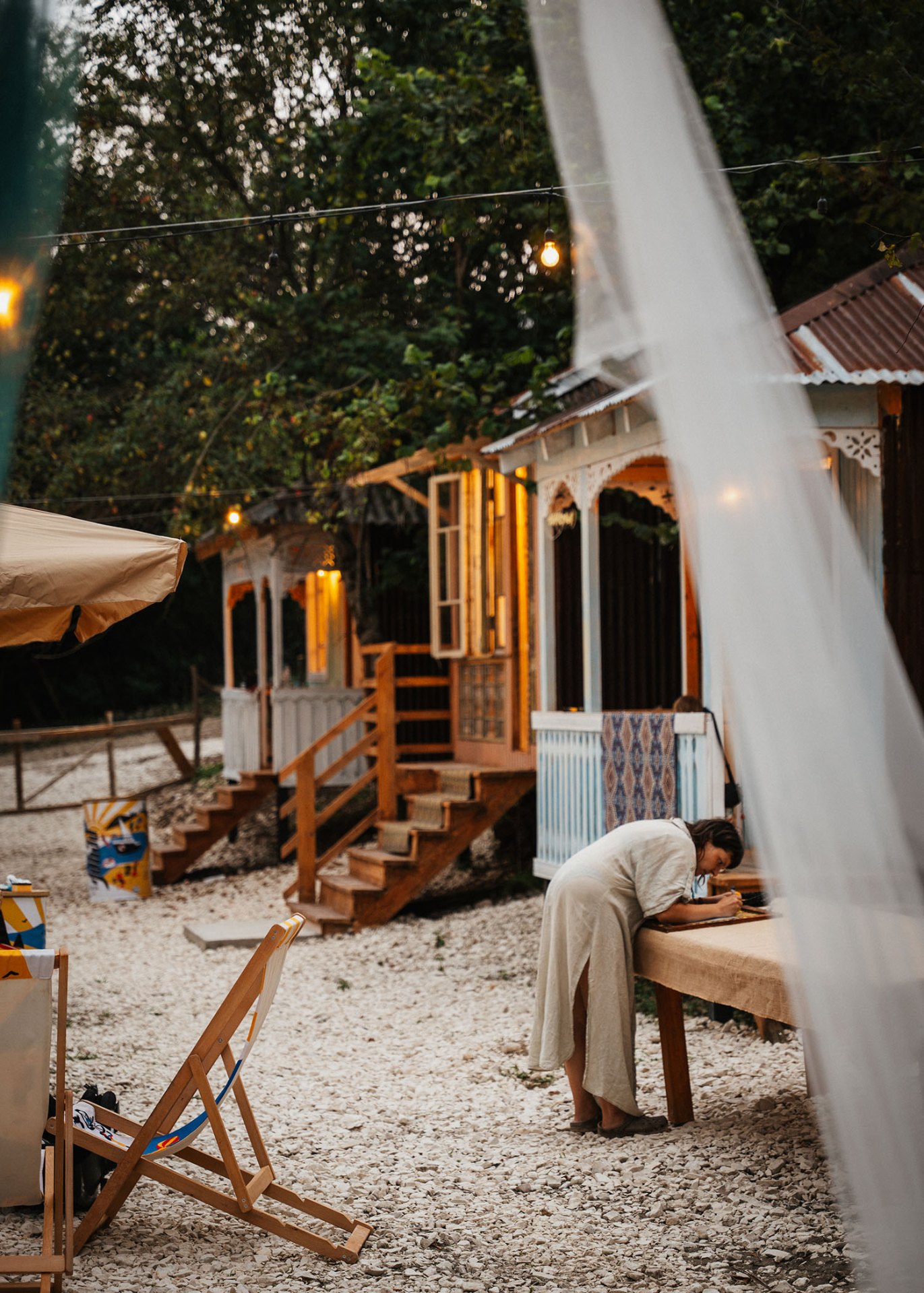 Row of wooden Oda cabins at dusk