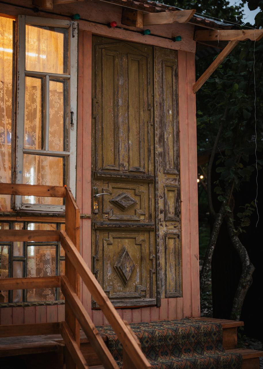 Hand-painted wooden door with Megrelian carvings at Gulsunda