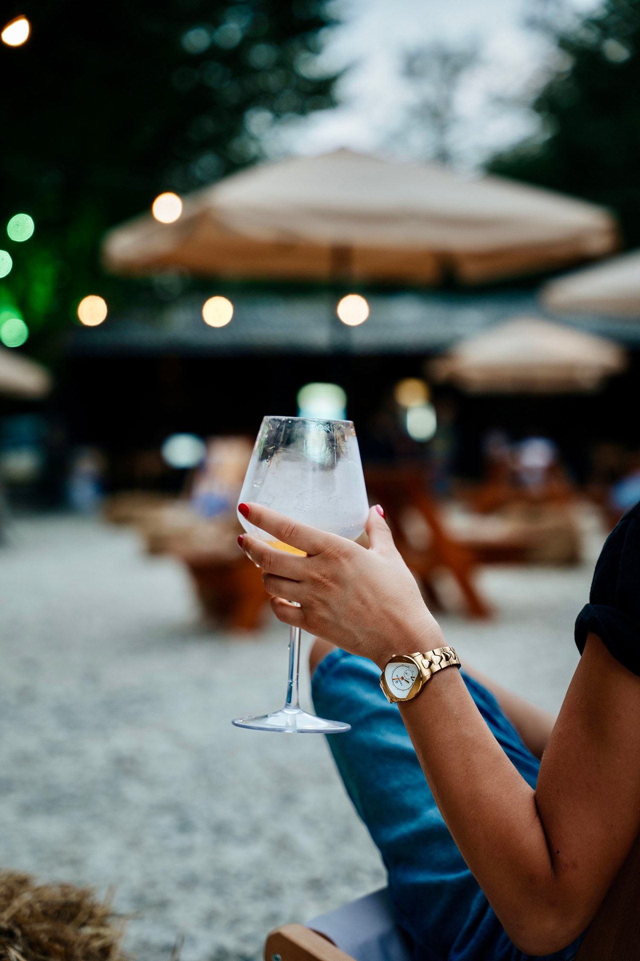 Guest toasting with a chilled drink in the courtyard